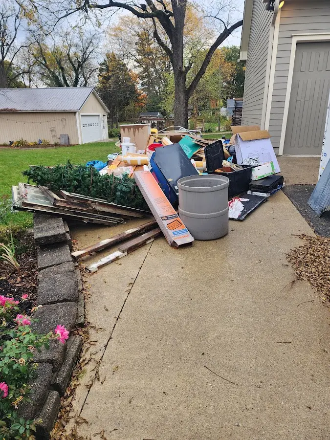 Dumpster being loaded with debris for 10 Yard Dumpster Rental in Caledonia